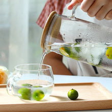 Load image into Gallery viewer, 1.7L Glass Water Pitcher with Handle and Bamboo Lid Drip-Free Tea Pitcher Glass Cold Hot Water Jug with 2 Cups Heat Resisttant